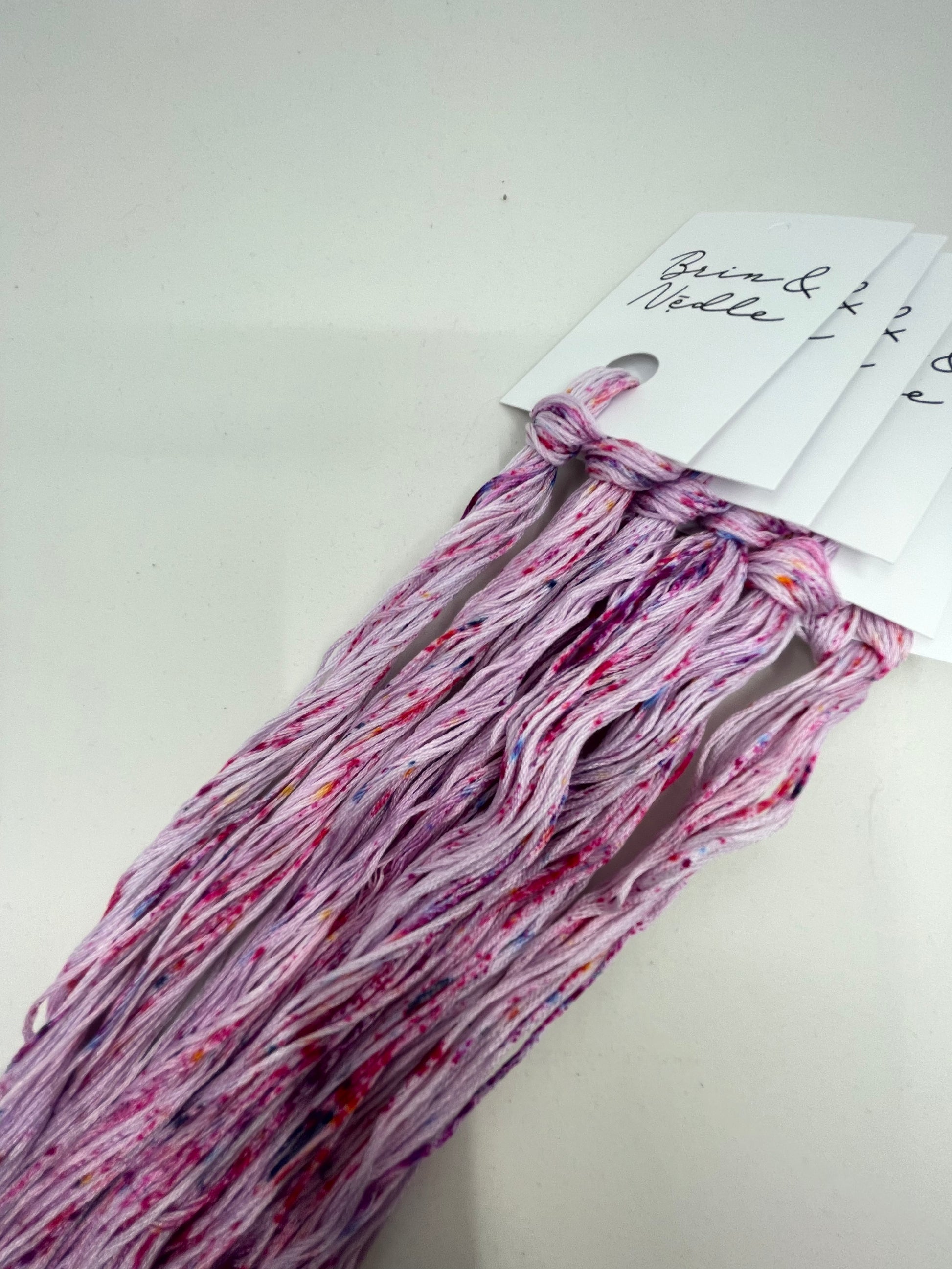 Six strand cotton floss that has a slight lavender base with pink and purple speckles