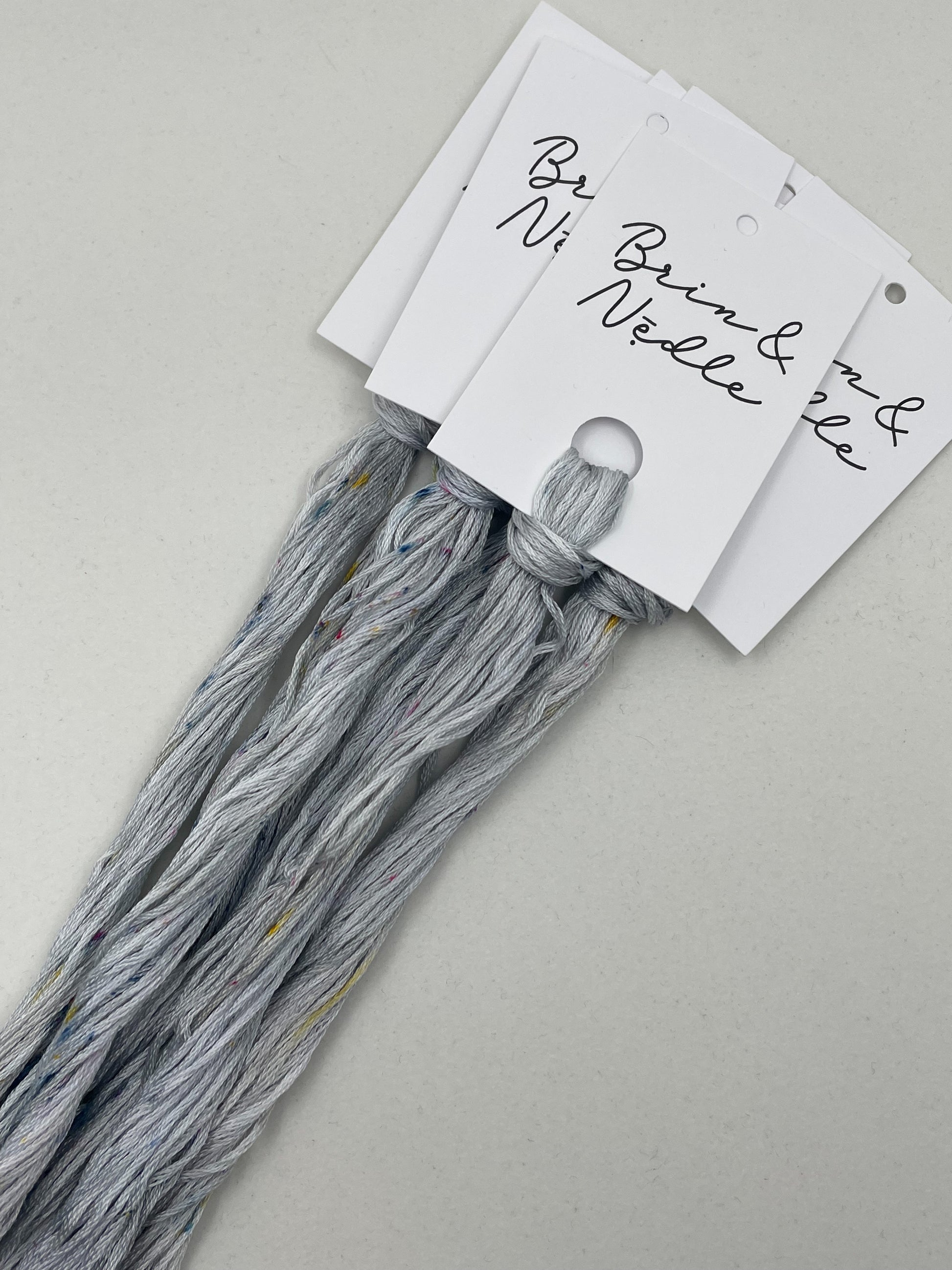 Six strand cotton floss in variegated light grey tones with Patty speckles